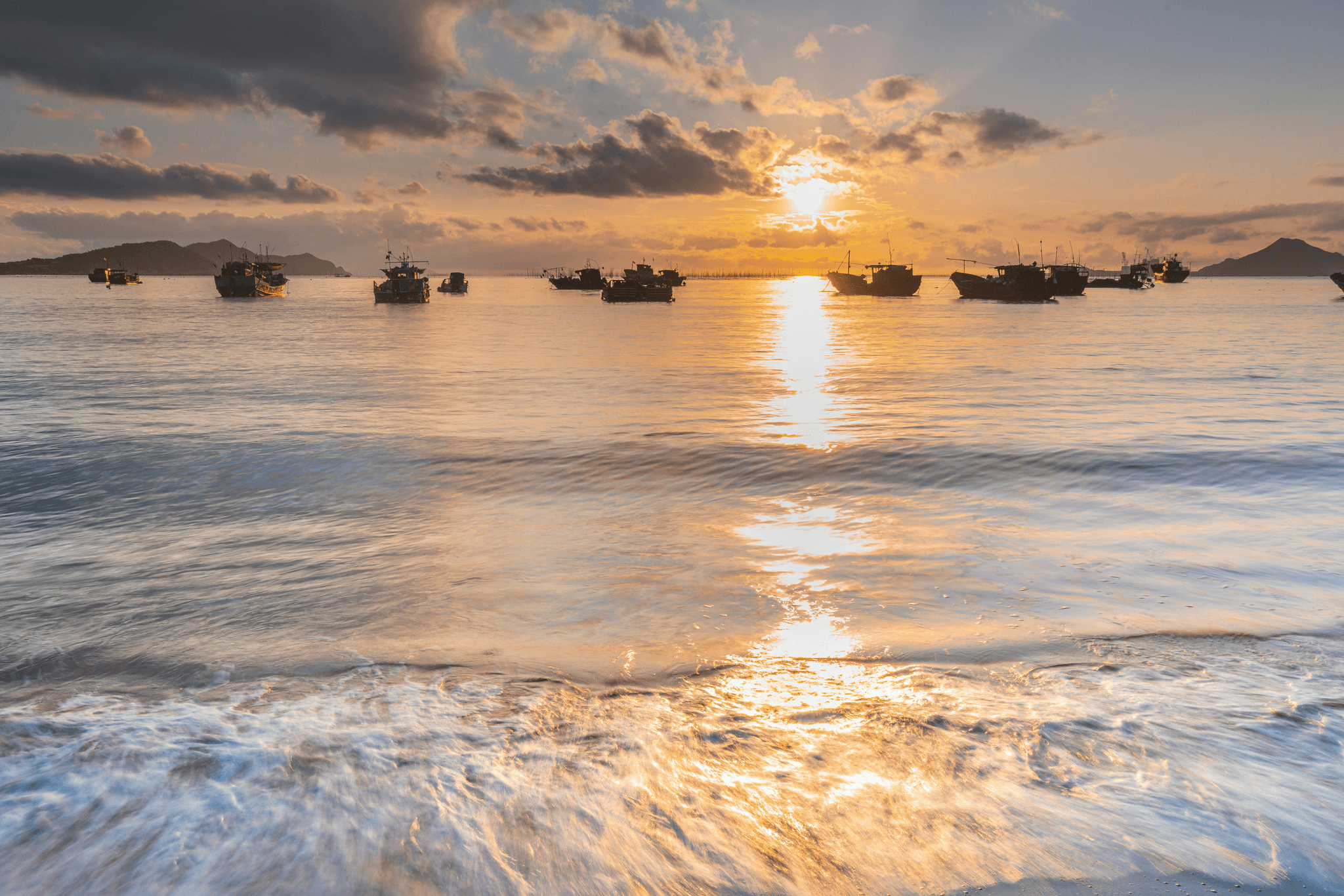 Aluminum landing boat resting peacefully by sandy shore.