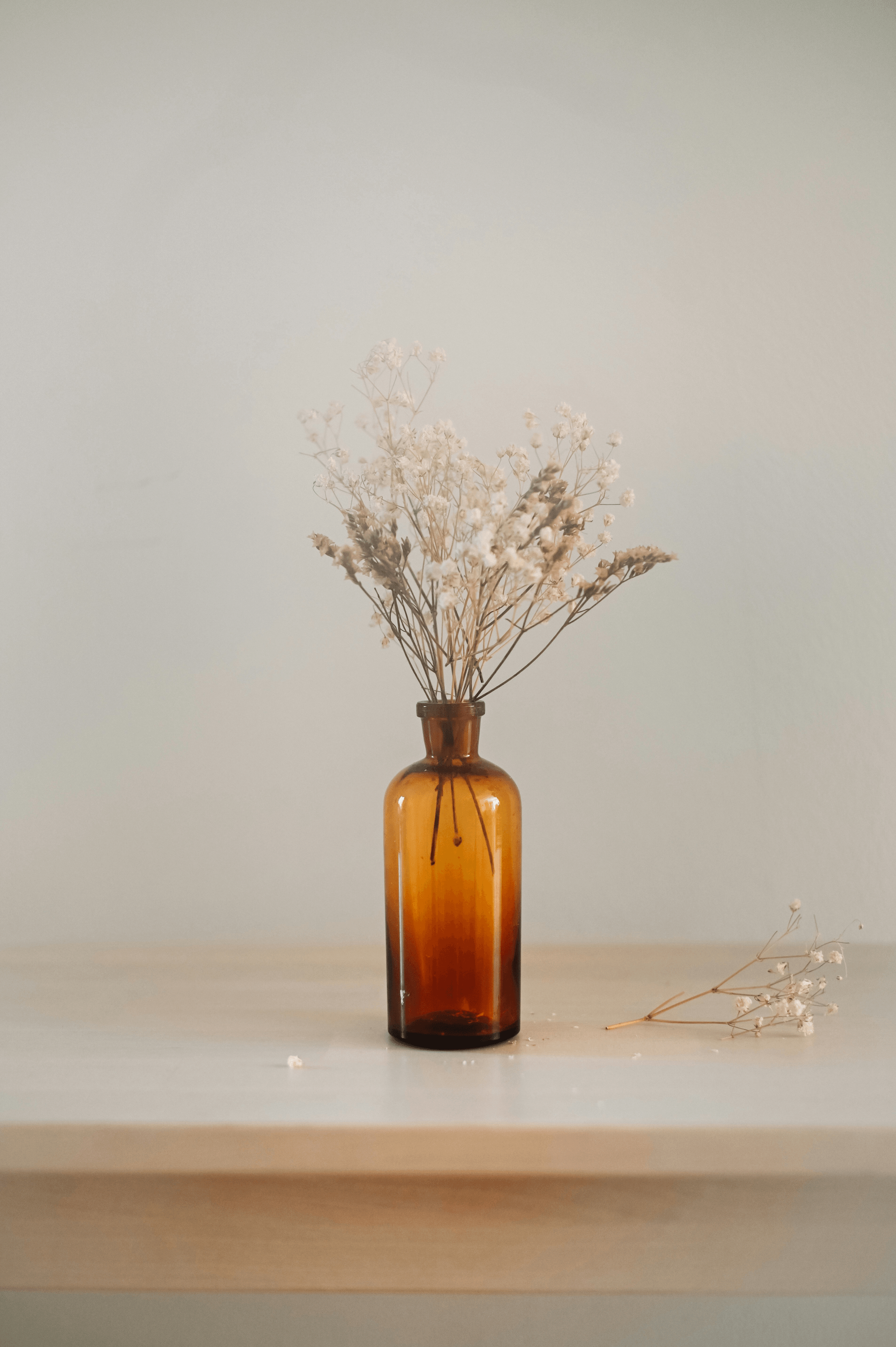 Beautiful dried flowers for sale in a glass vase.
