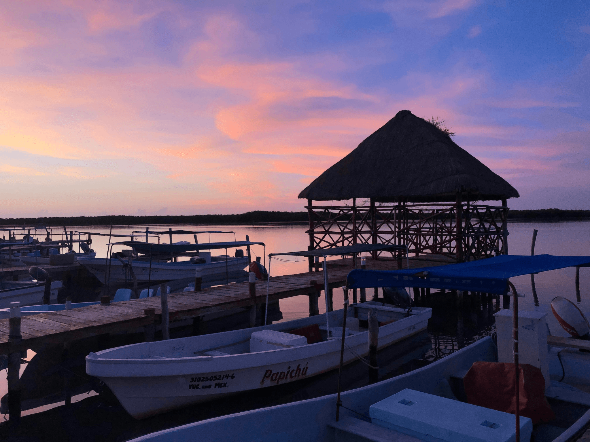 aluminum fishing boat with cabin at sunset