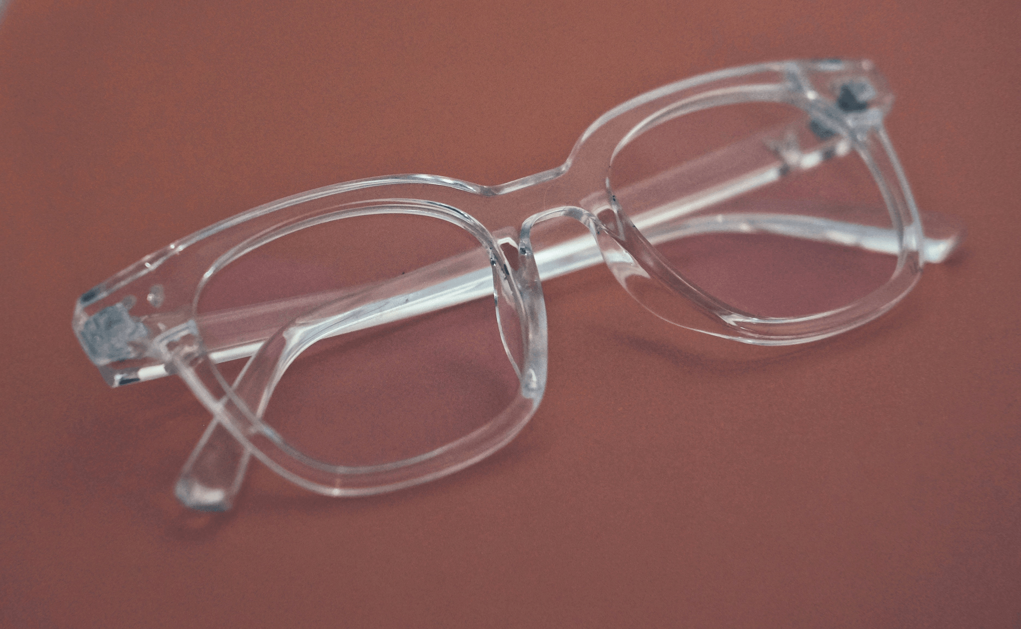 Stylish plastic frames with adjustable nose pads on display.