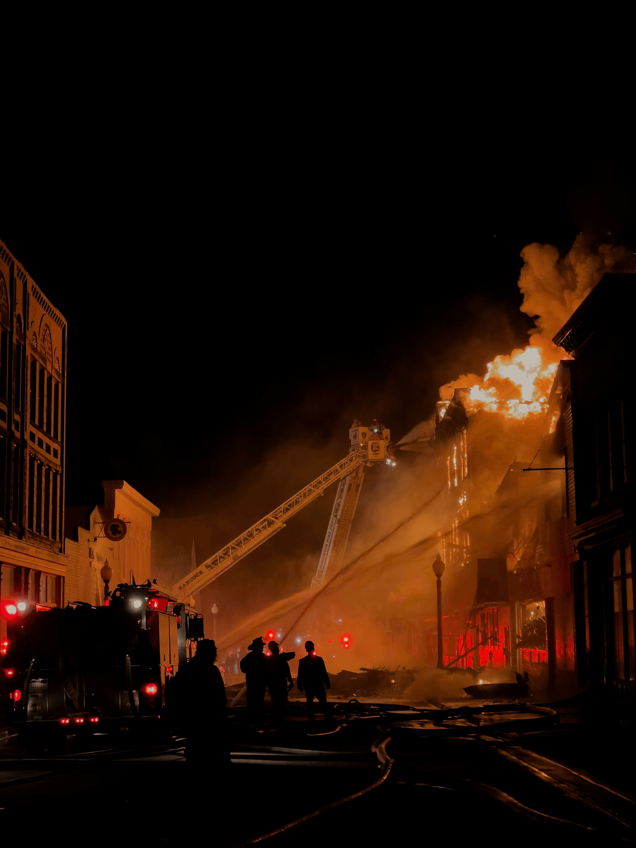 Fire fighting foam application during nighttime emergency response.
