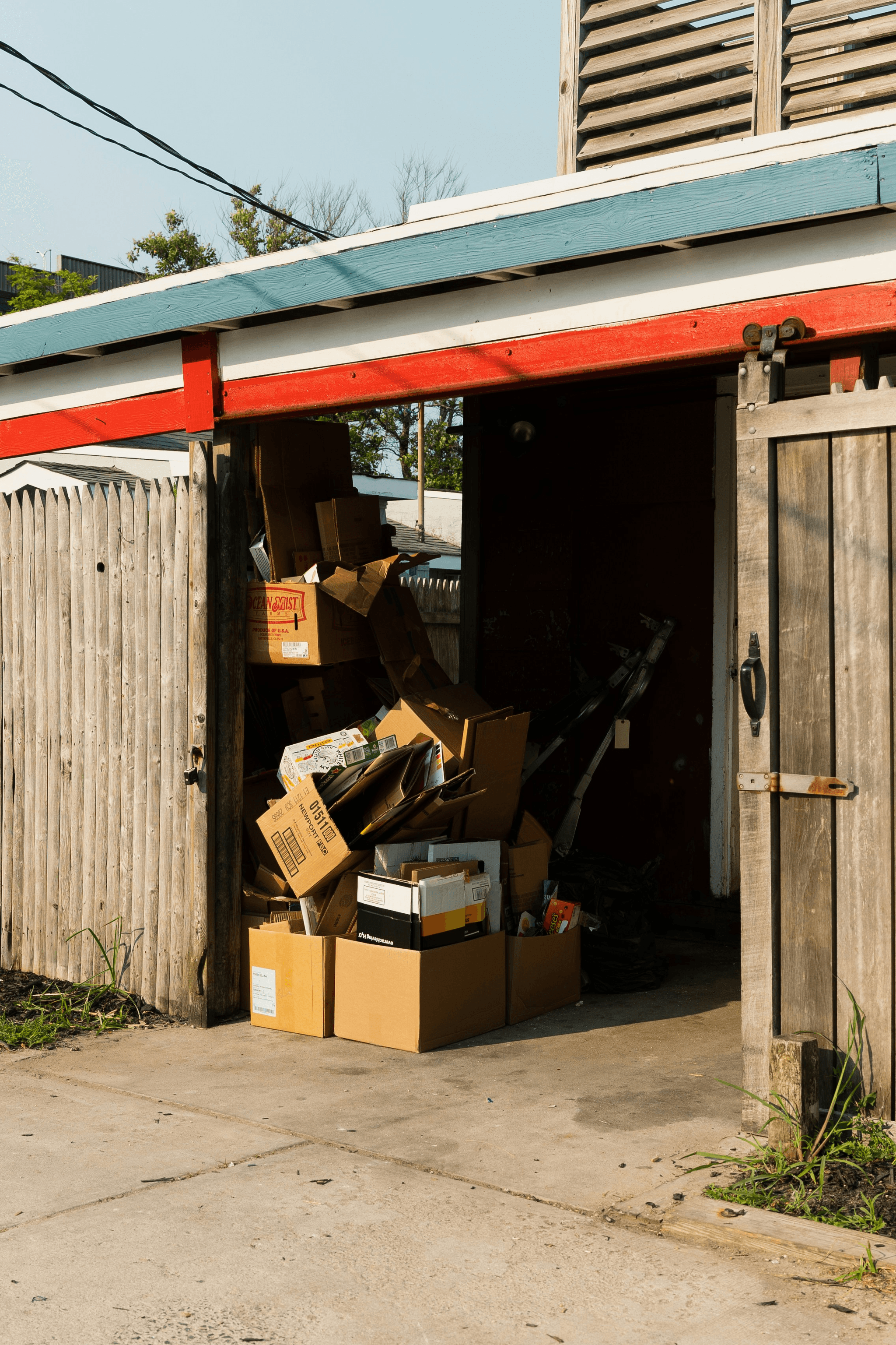Flat pack storage container being assembled in a cluttered garage.