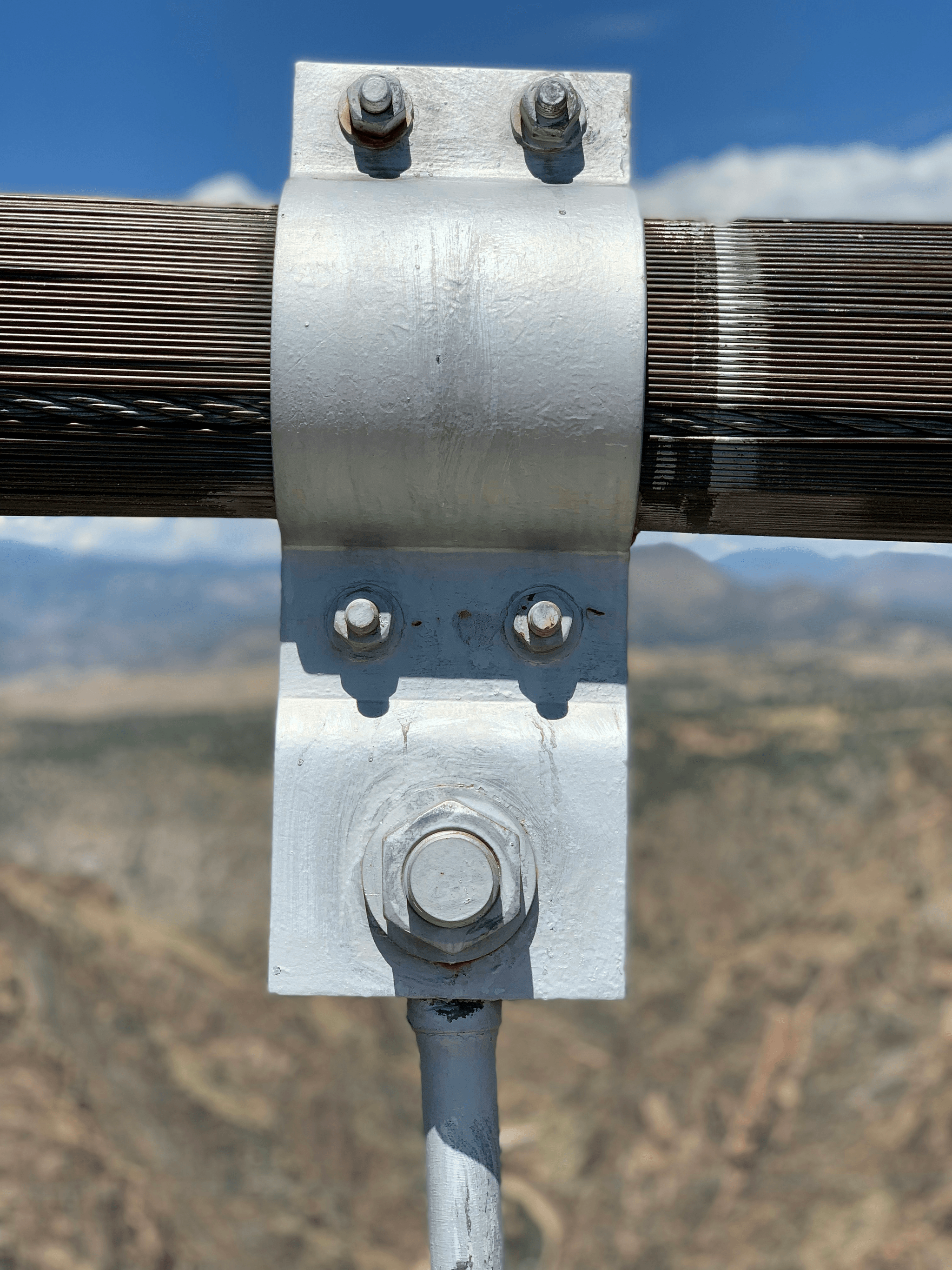 Close-up view of pole clamps securing conductors