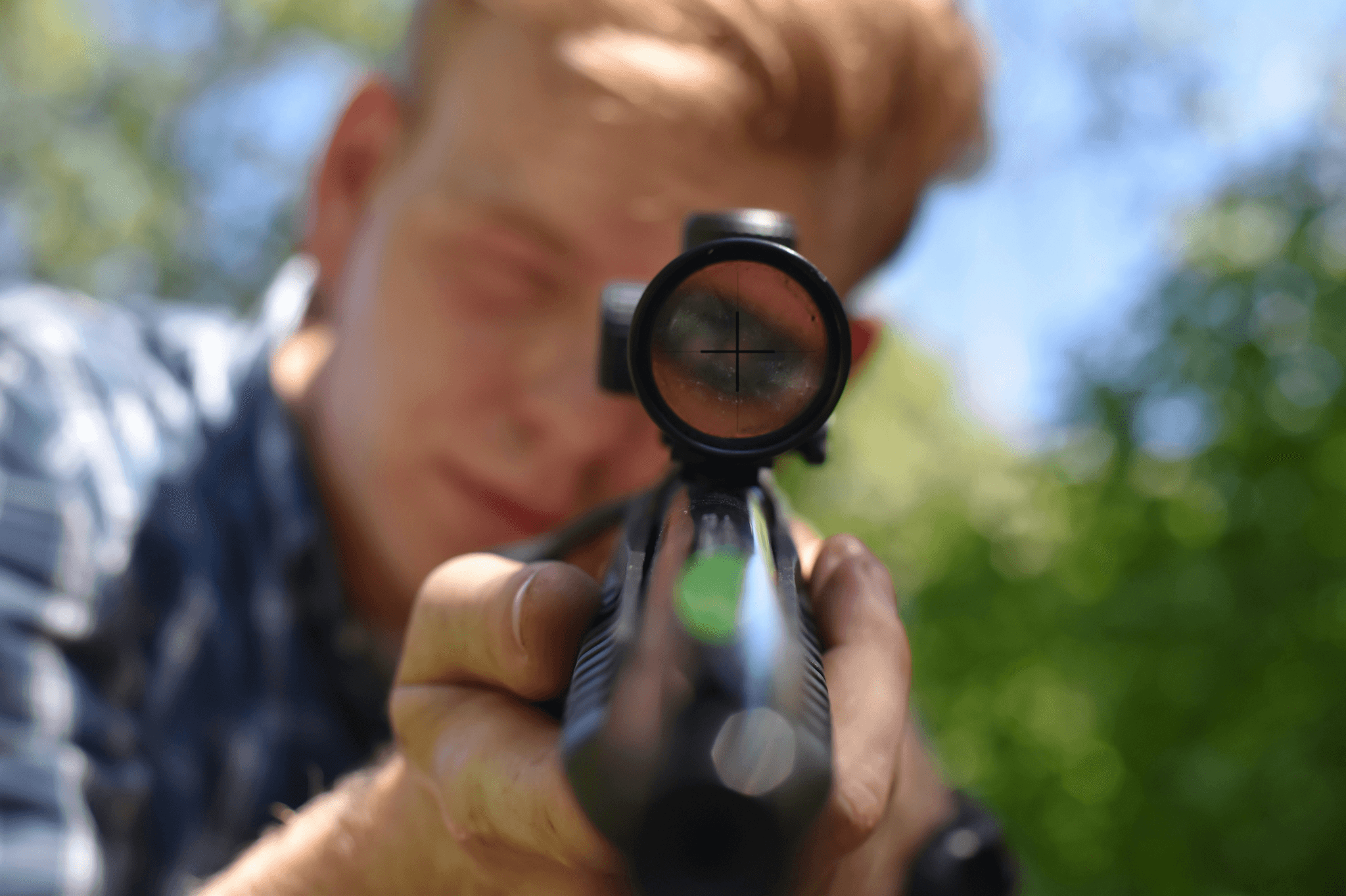 Shooter wearing prescription shooting glasses focusing on target.