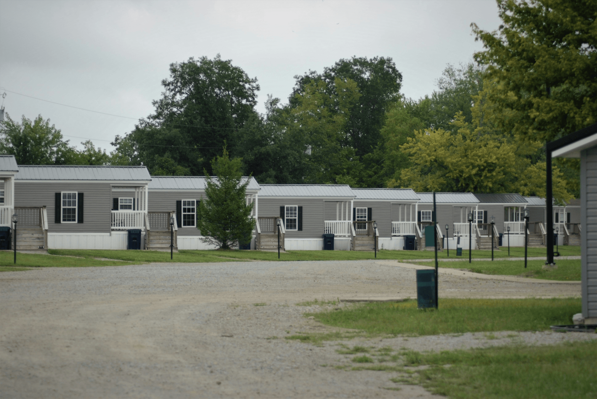 Illustration of different types of mobile homes on a sunny lot