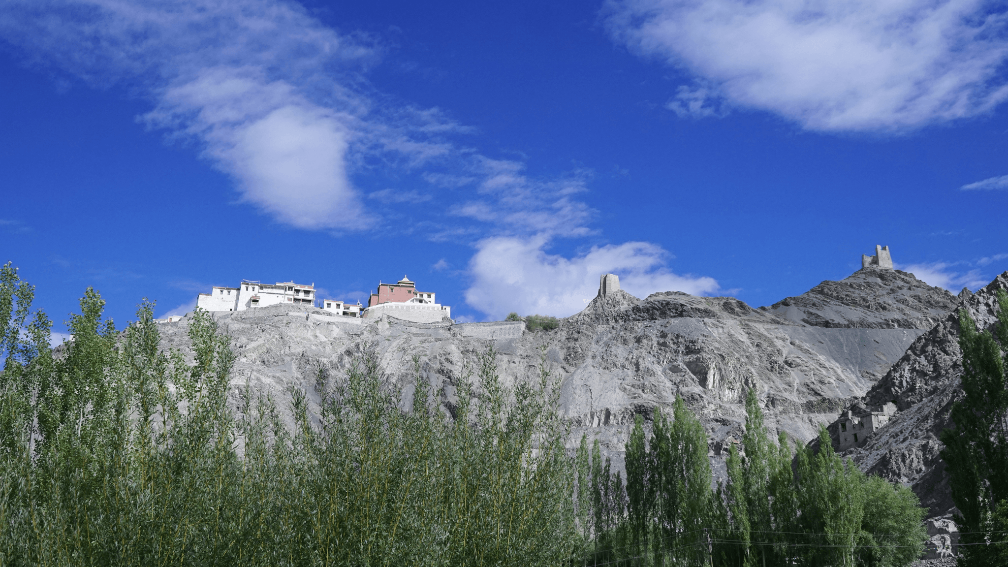 Aerial view of Sakya Monastery surrounded by mountains