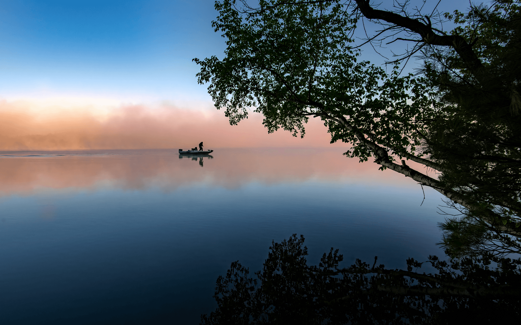 Best boat manufacturers - A sleek Lund Boat cruising through calm waters