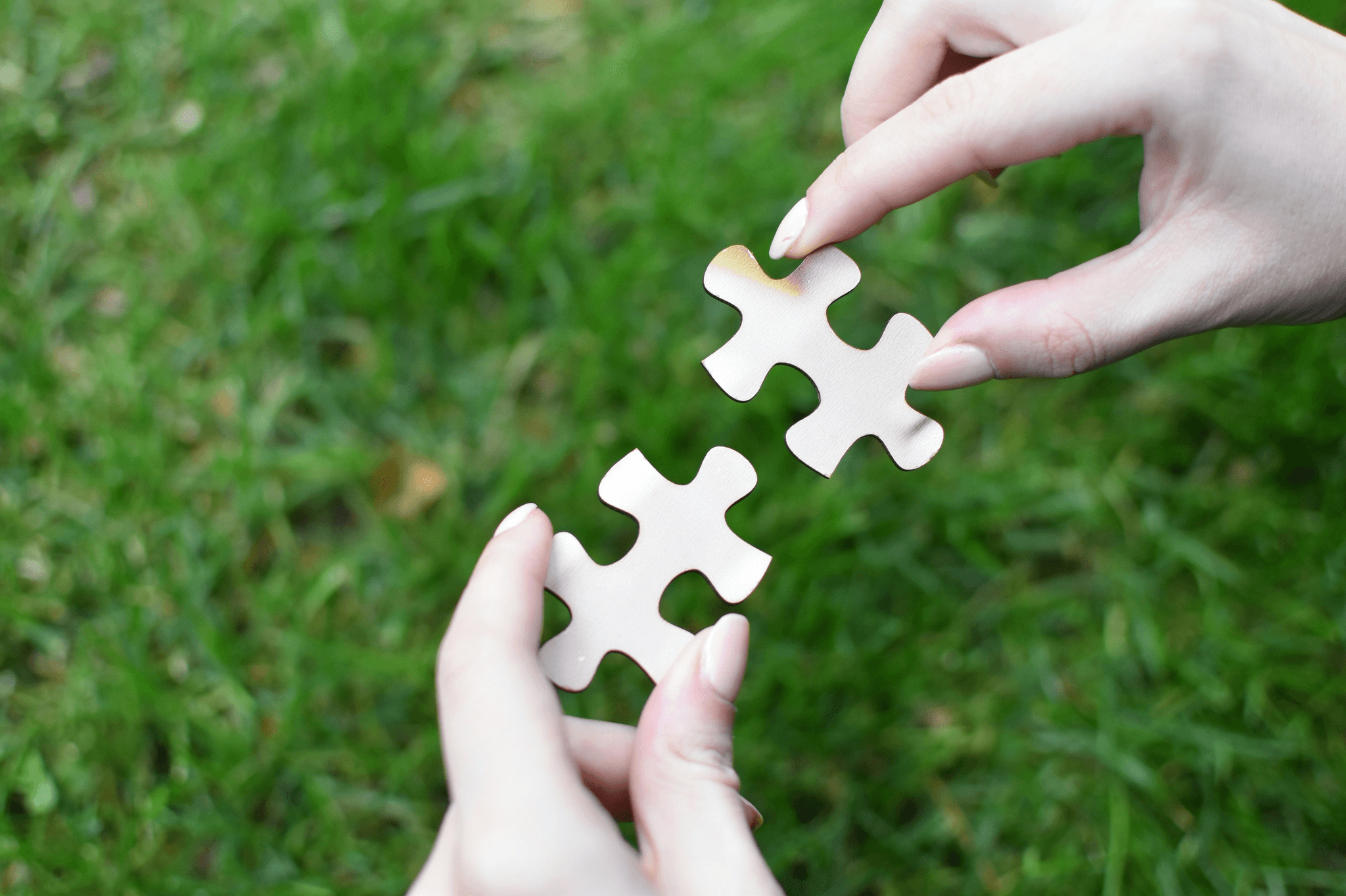 Two puzzle pieces fitting together perfectly representing the seamless partnership between businesses and sourcing services.