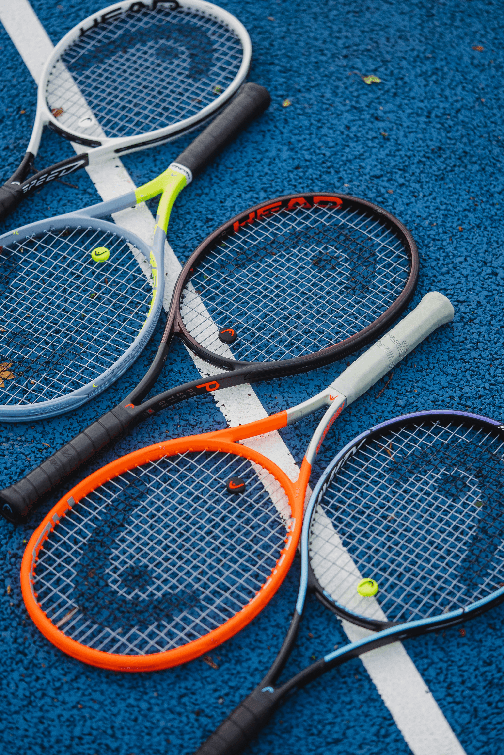 Tennis equipment inspection setup with tools and rackets.