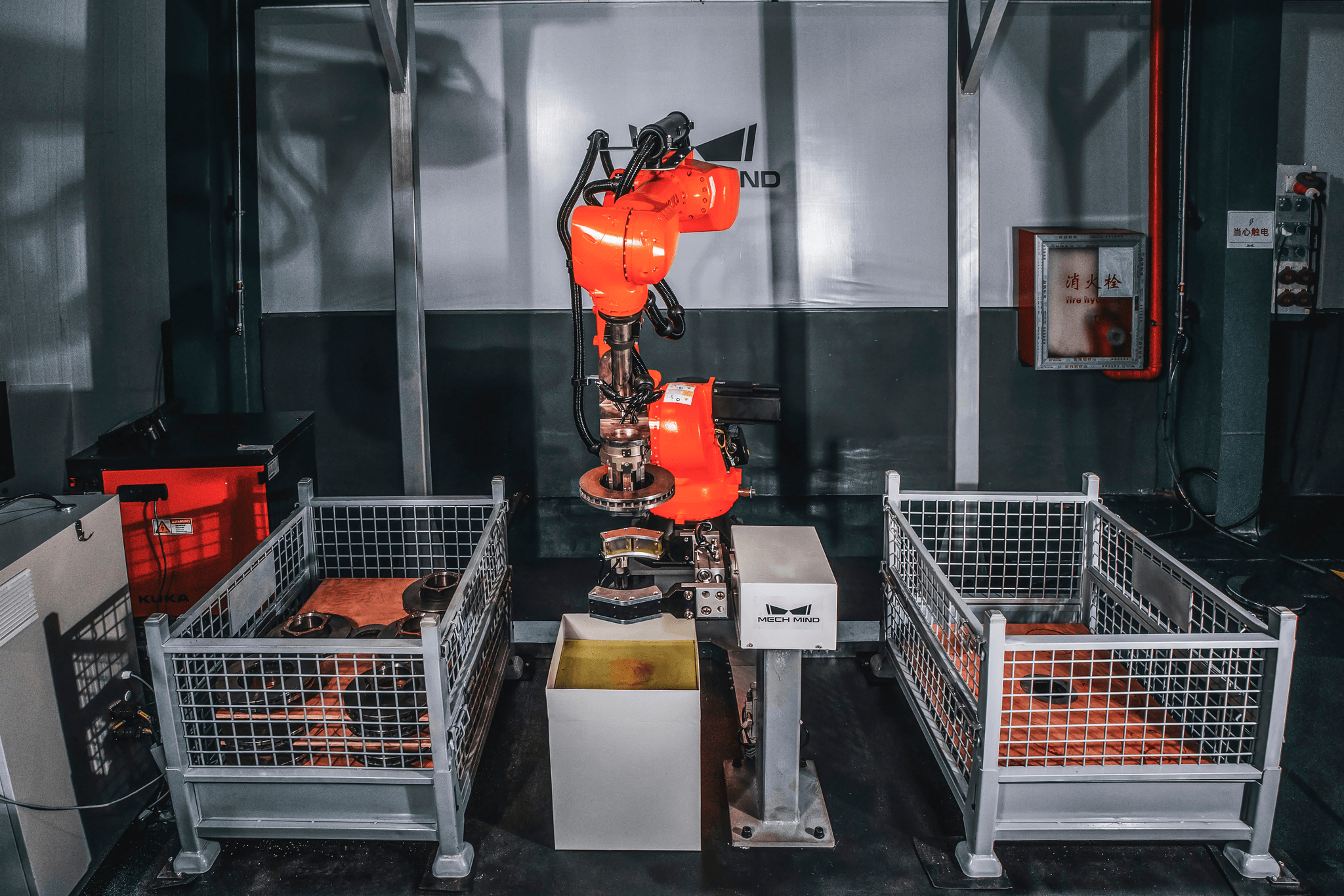 Manufacturing facility with robotic arms assembling components.