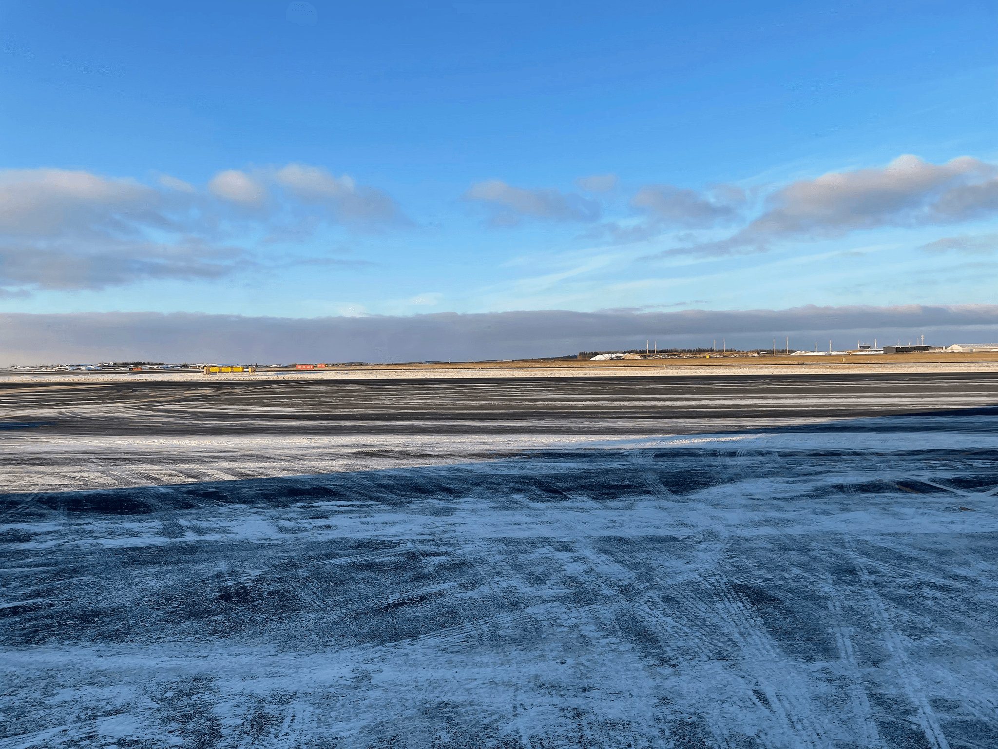 airport snow removal equipment clearing runway