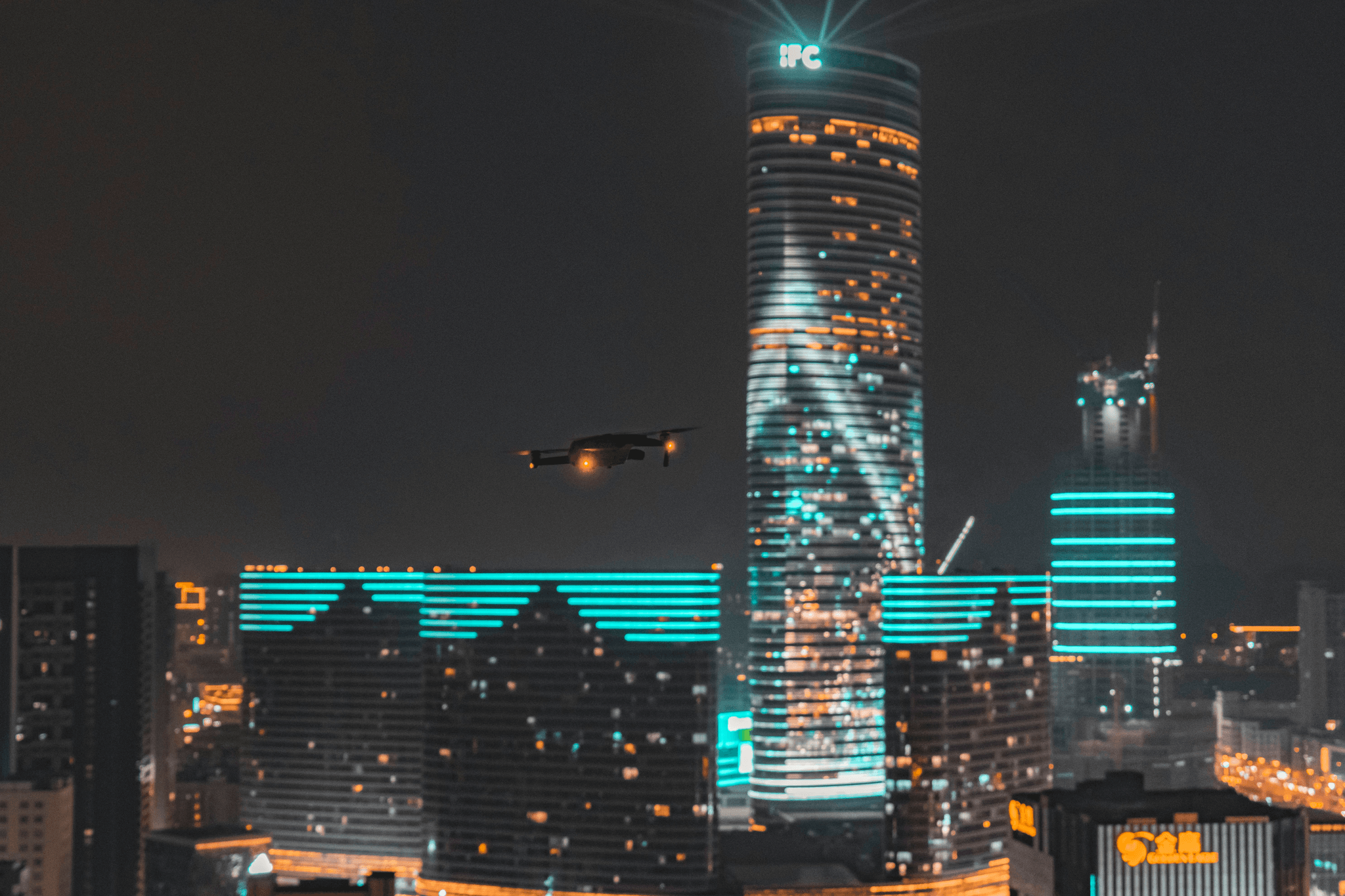 Futuristic city skyline with drones flying overhead - Anti Drone System