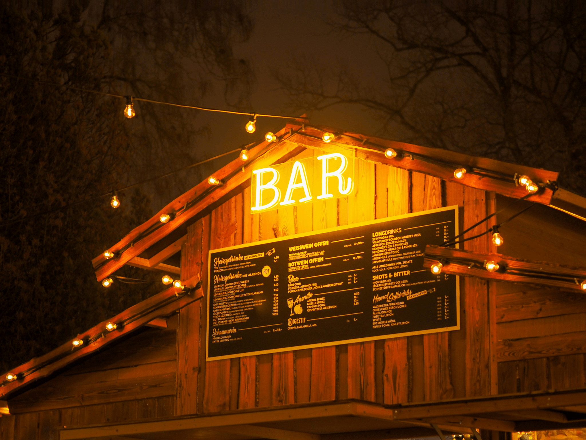 Colorful string lights hanging above portable outdoor bar