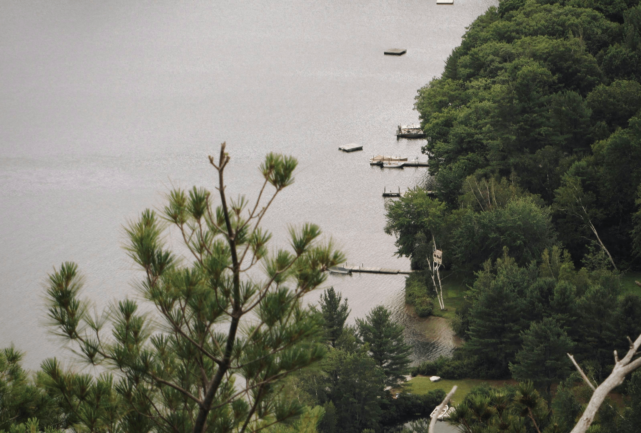 small pontoon boat anchored in tranquil lake waters