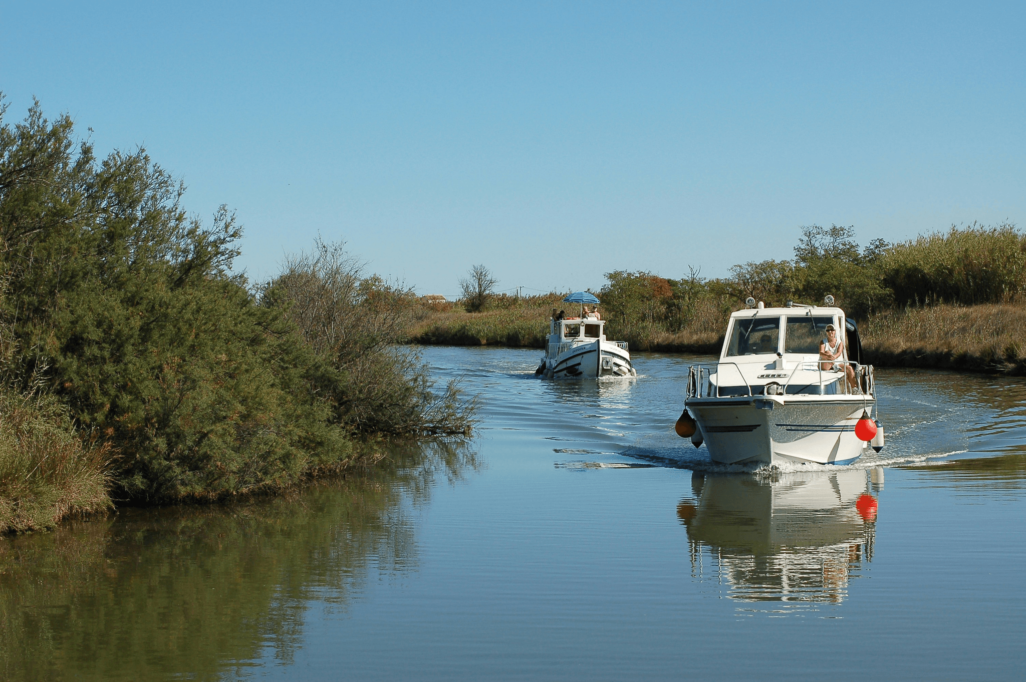 An 18 foot aluminum fishing boat navigating through a narrow channel