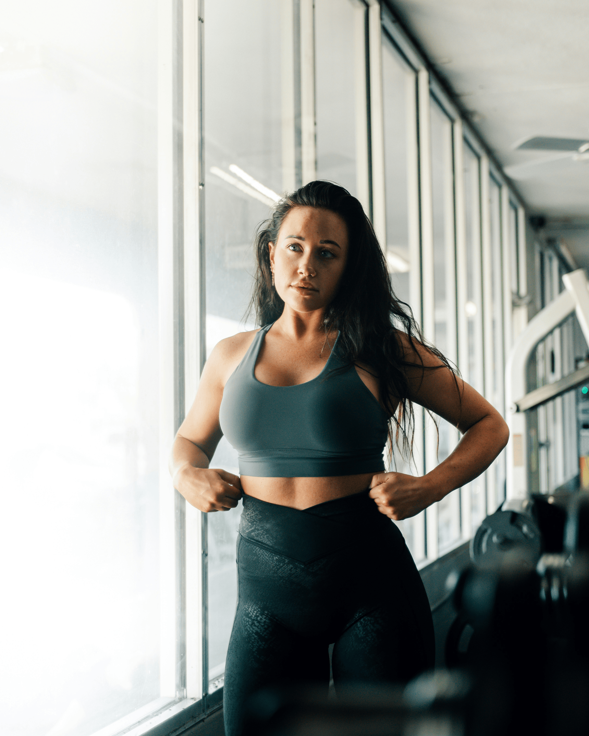 A fit woman in gym wear reflecting athletic performance and body composition transformation with Lady Reset wellness