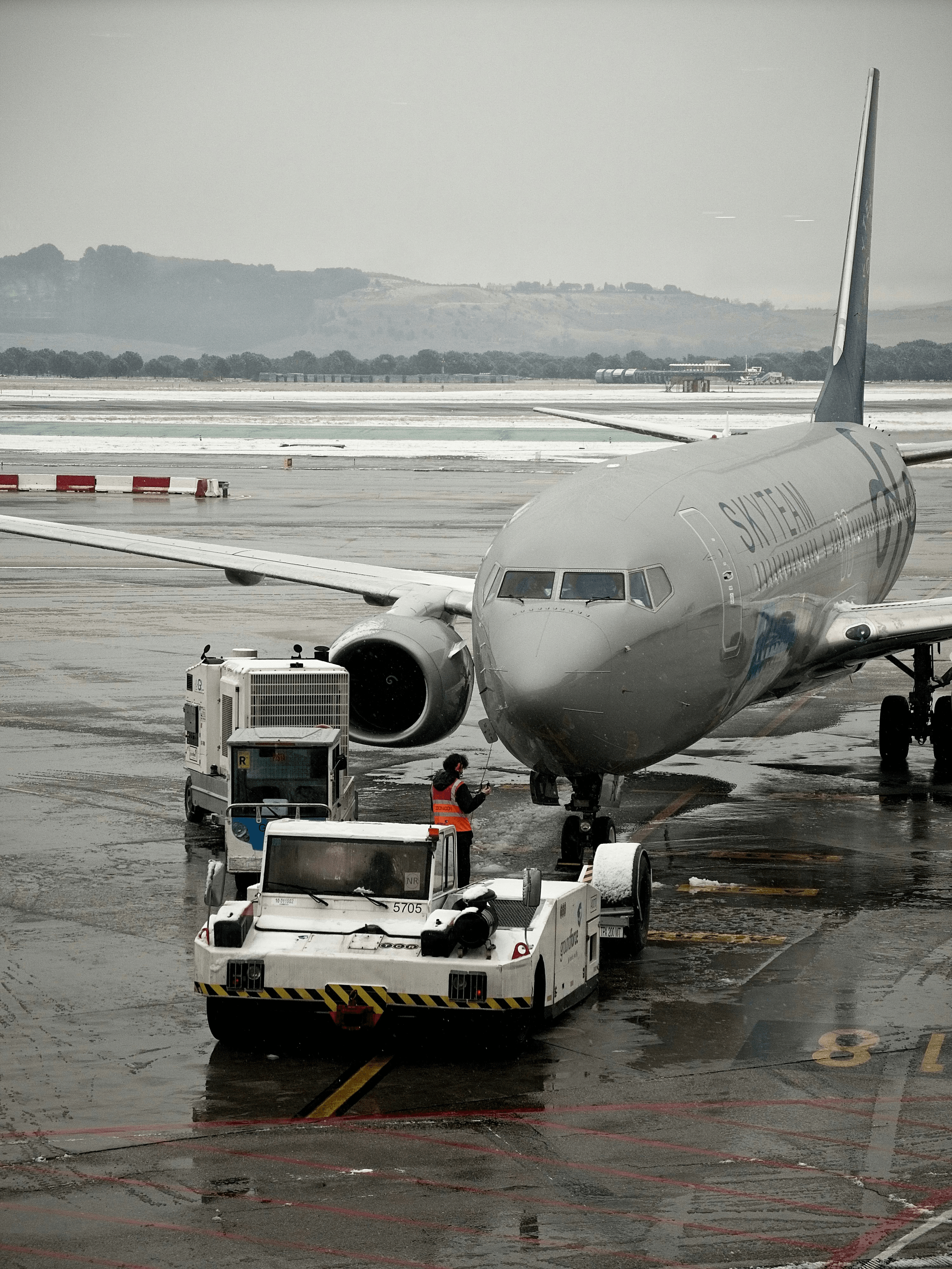 aviation refueler servicing an aircraft on tarmac