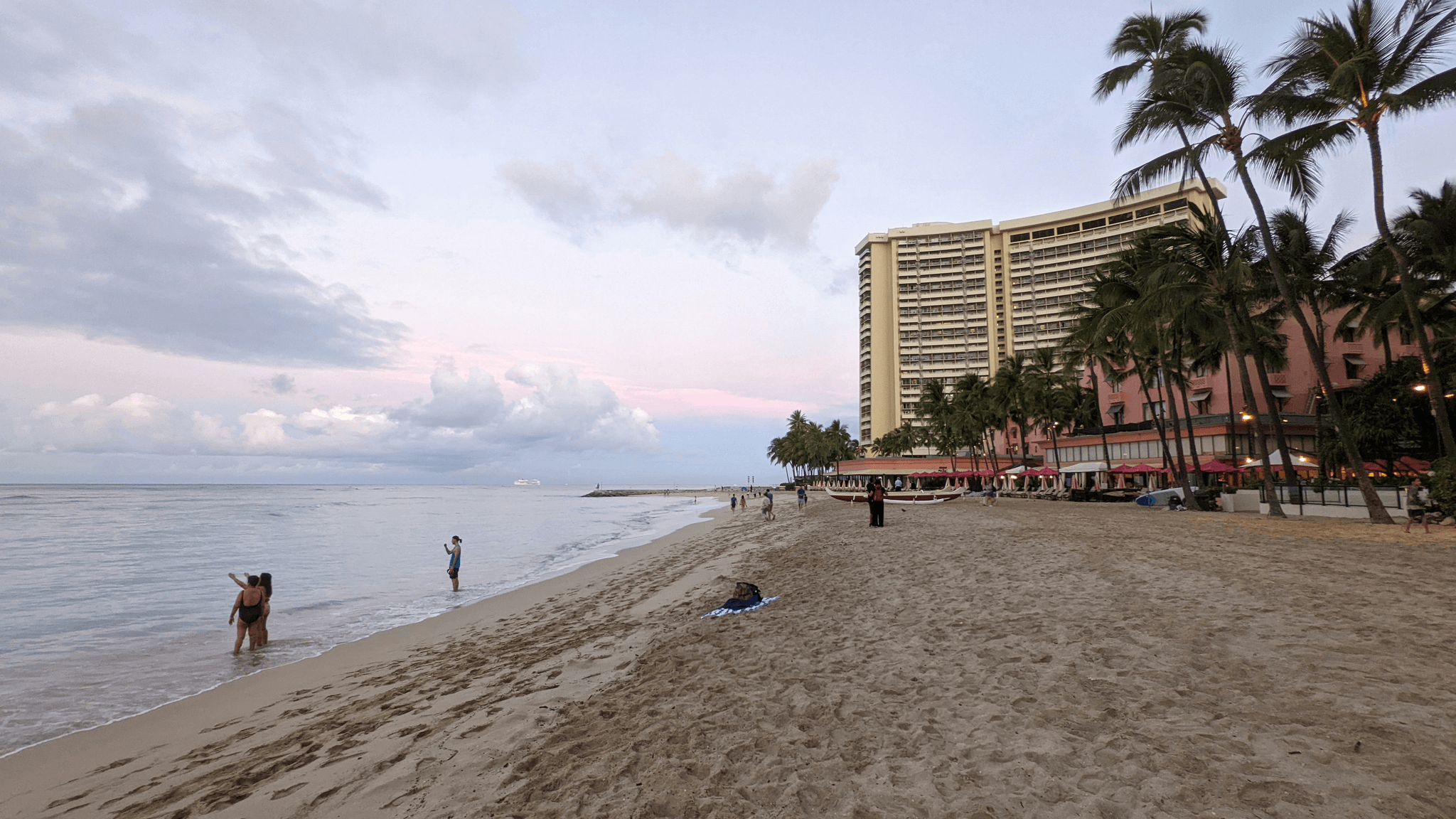 Families enjoying sunset on the beach at Aulani resorts