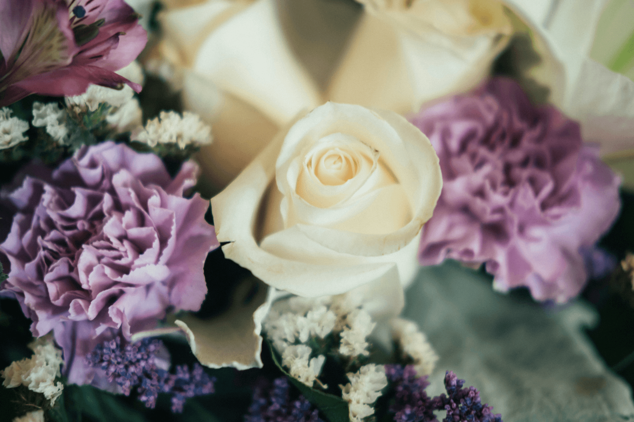Captivating roses & lovely lavenders create an enchanting floral arrangement.