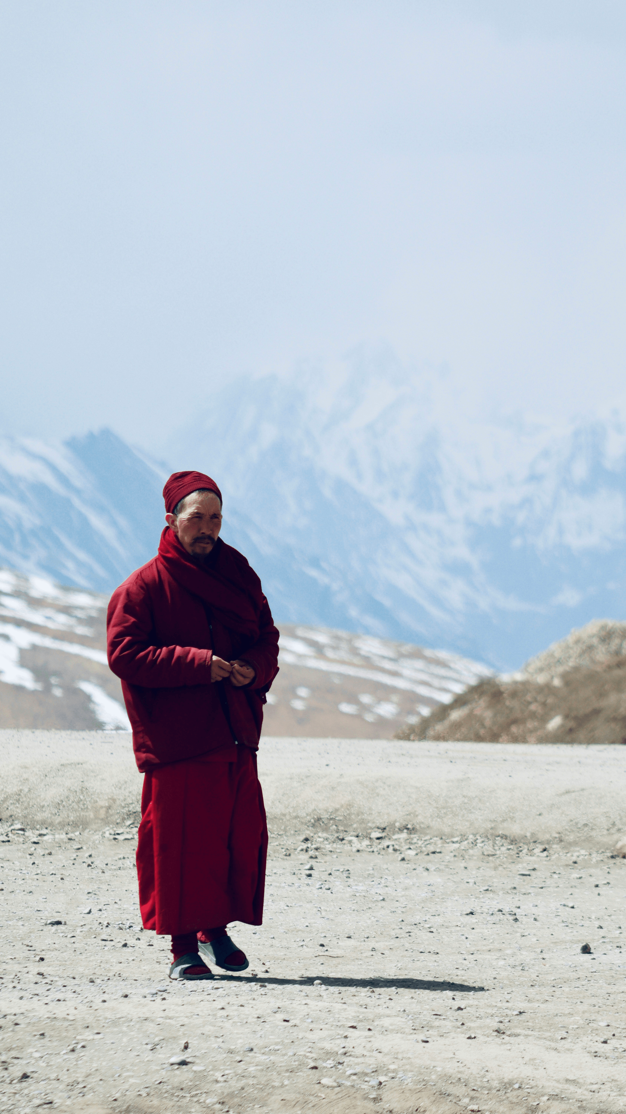 Monks meditating on plateau in tibet surrounded by mountains