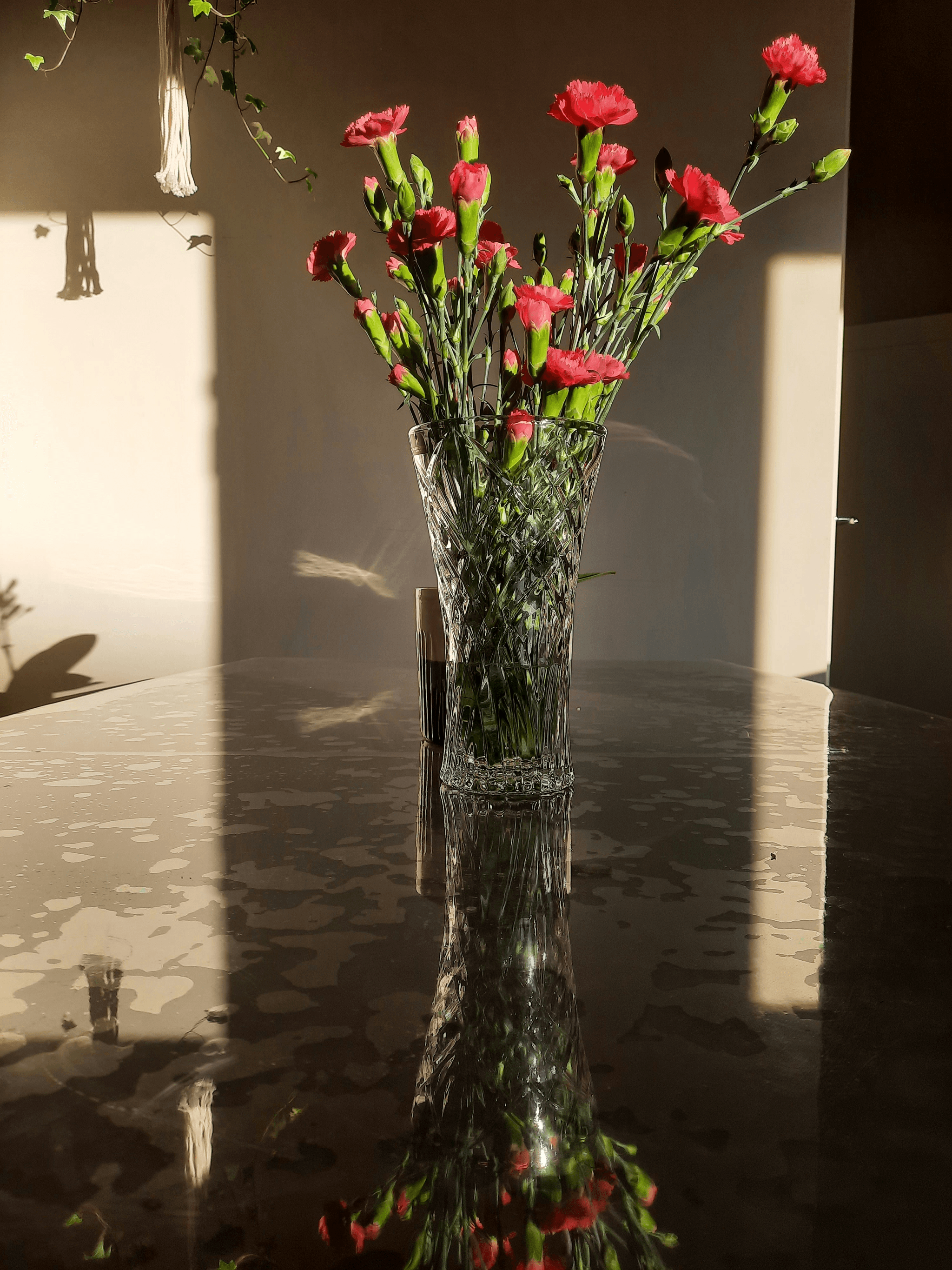 Large dried flower arrangements showcased in a glass vase