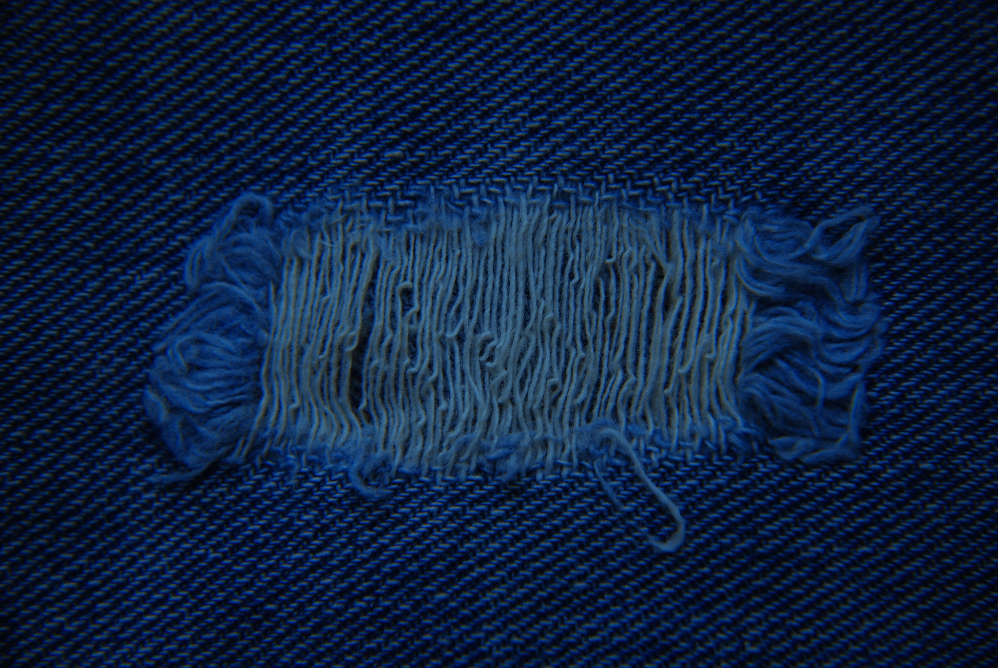 fabric defects visible on snagged textile surface