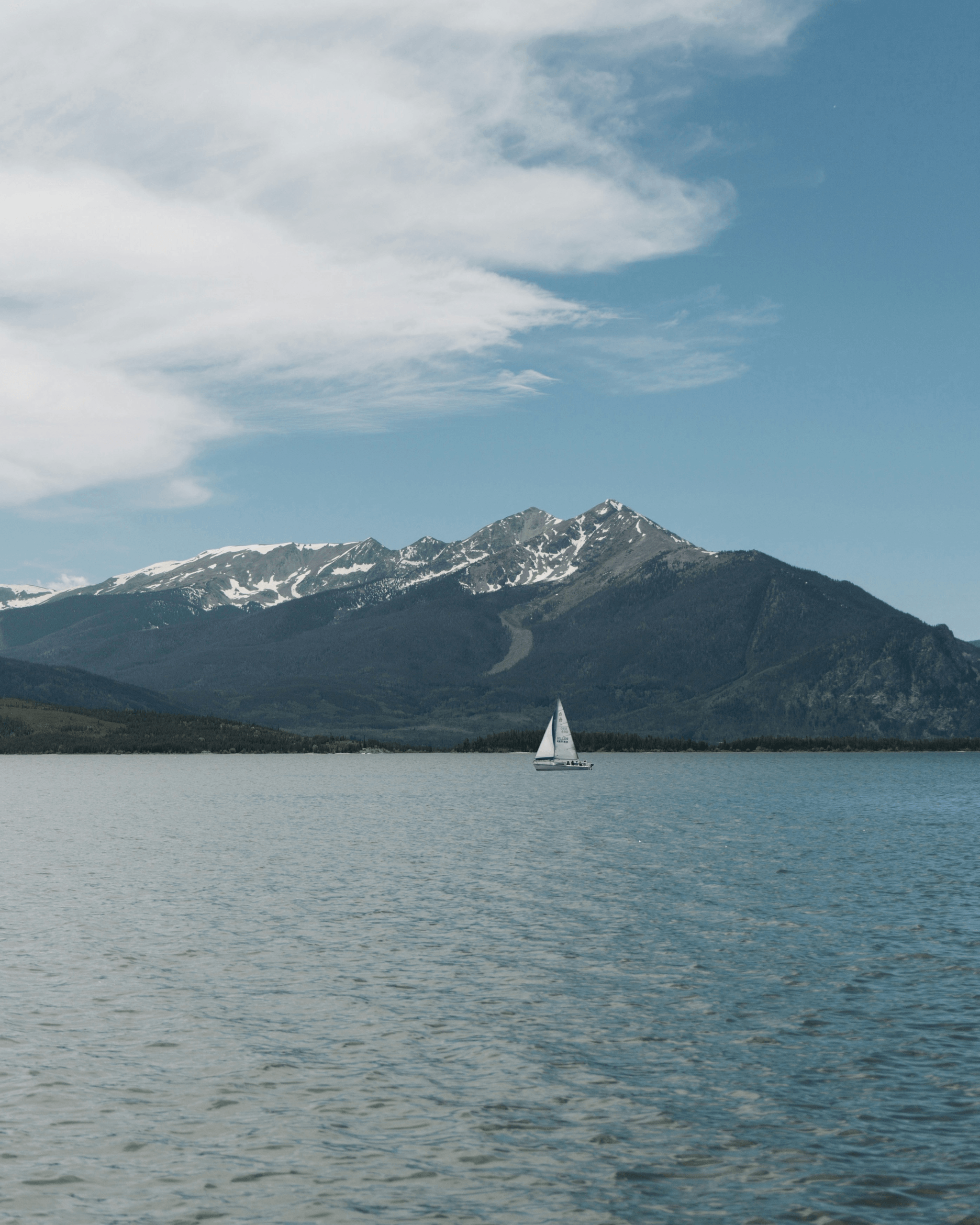 Small aluminum boat navigating serene waters
