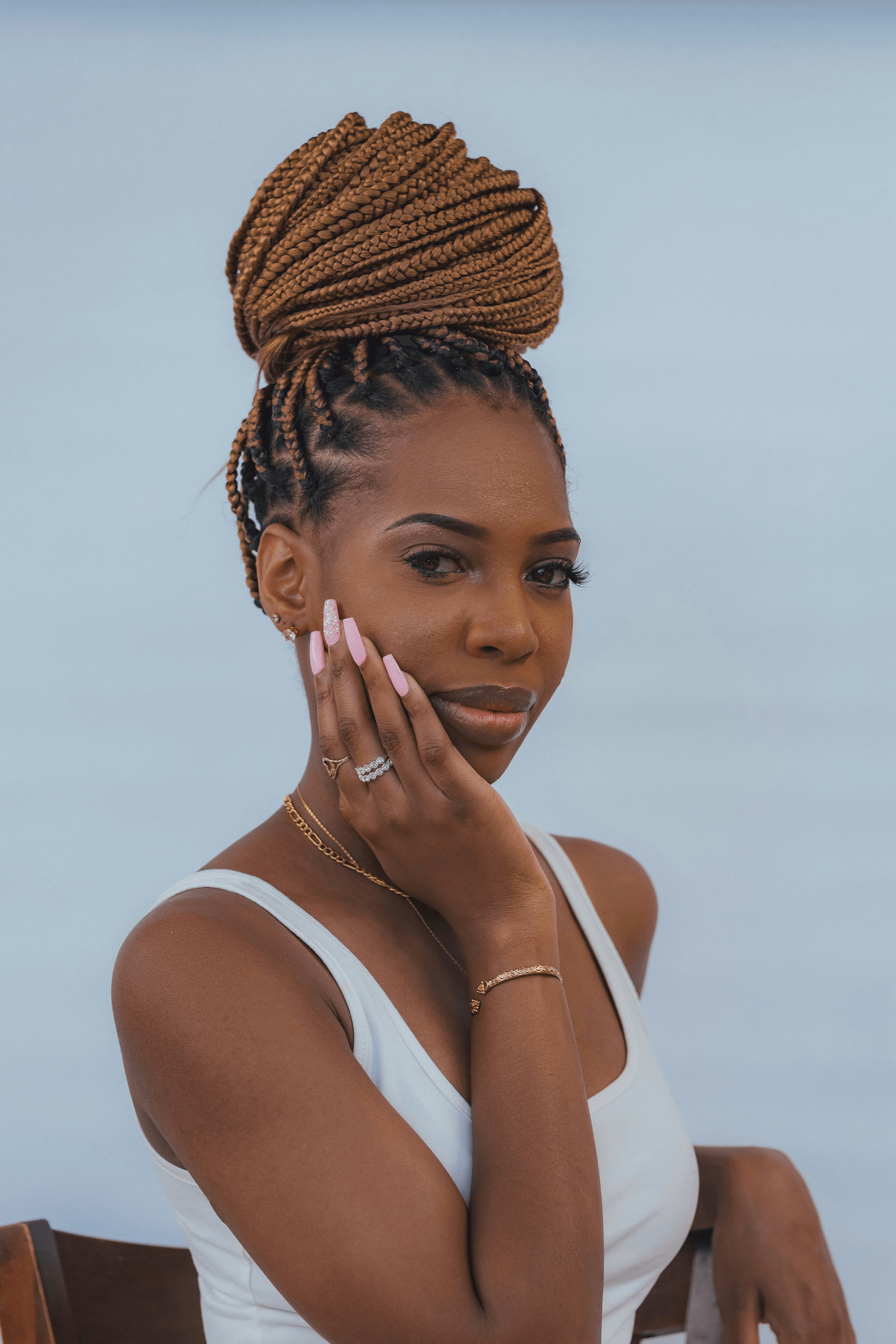 Stylish woman showcasing bulk virgin hair in trendy box braids.