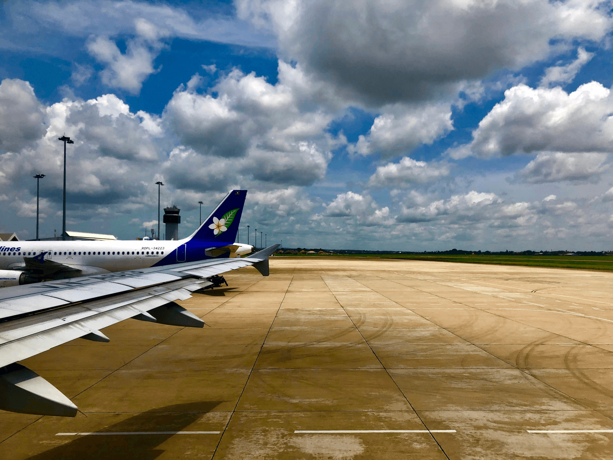 Aerial view of an airport runway with planes taxiing on the tarmac
