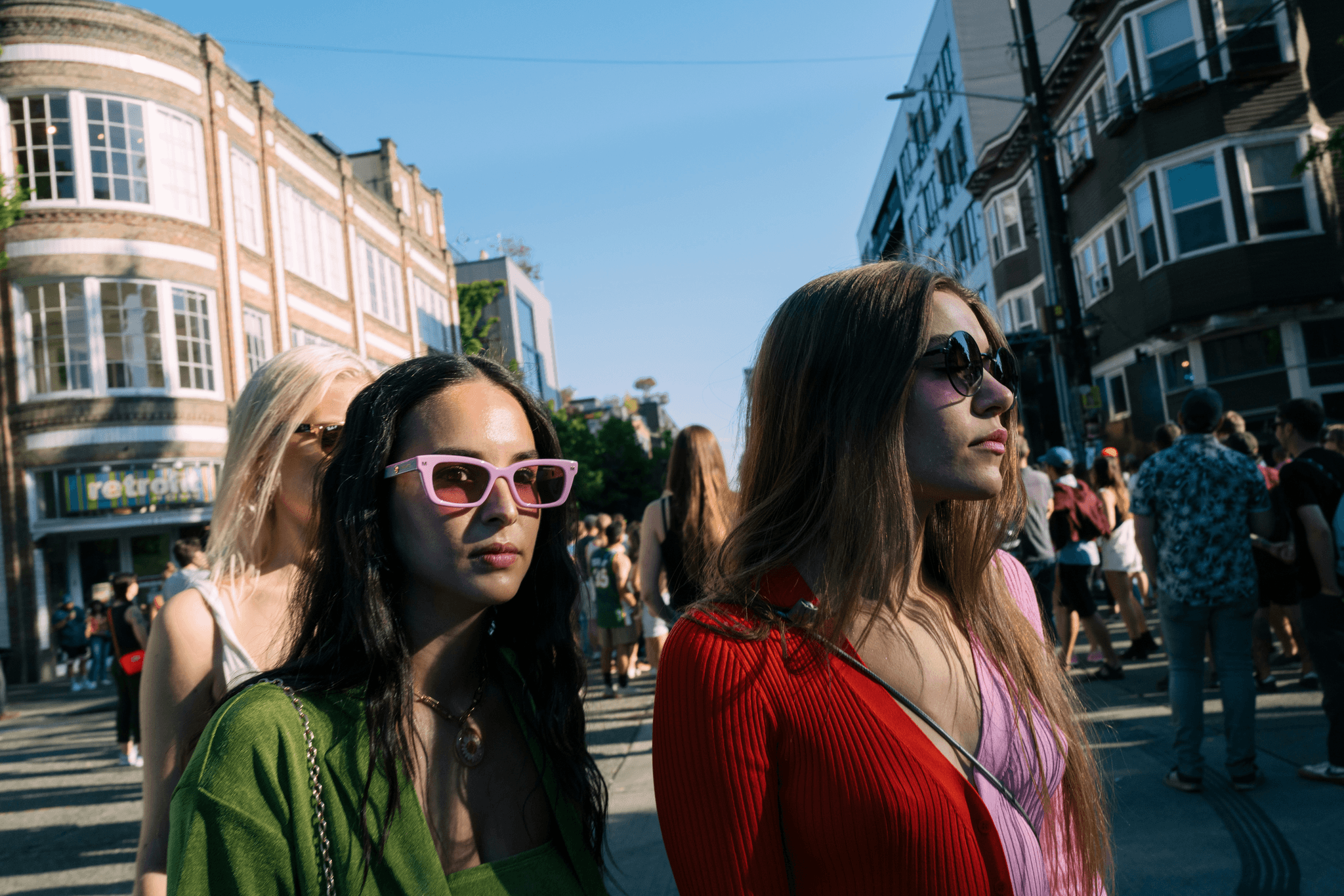 Group wearing cheap plastic sunglasses in bulk at an outdoor event.