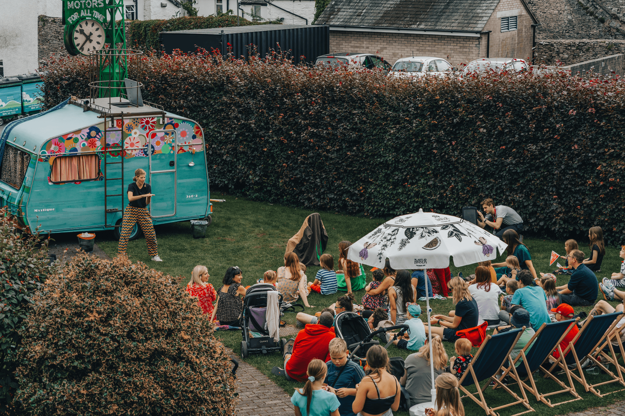 People enjoying delicious meals from portable restaurants at an outdoor festival.