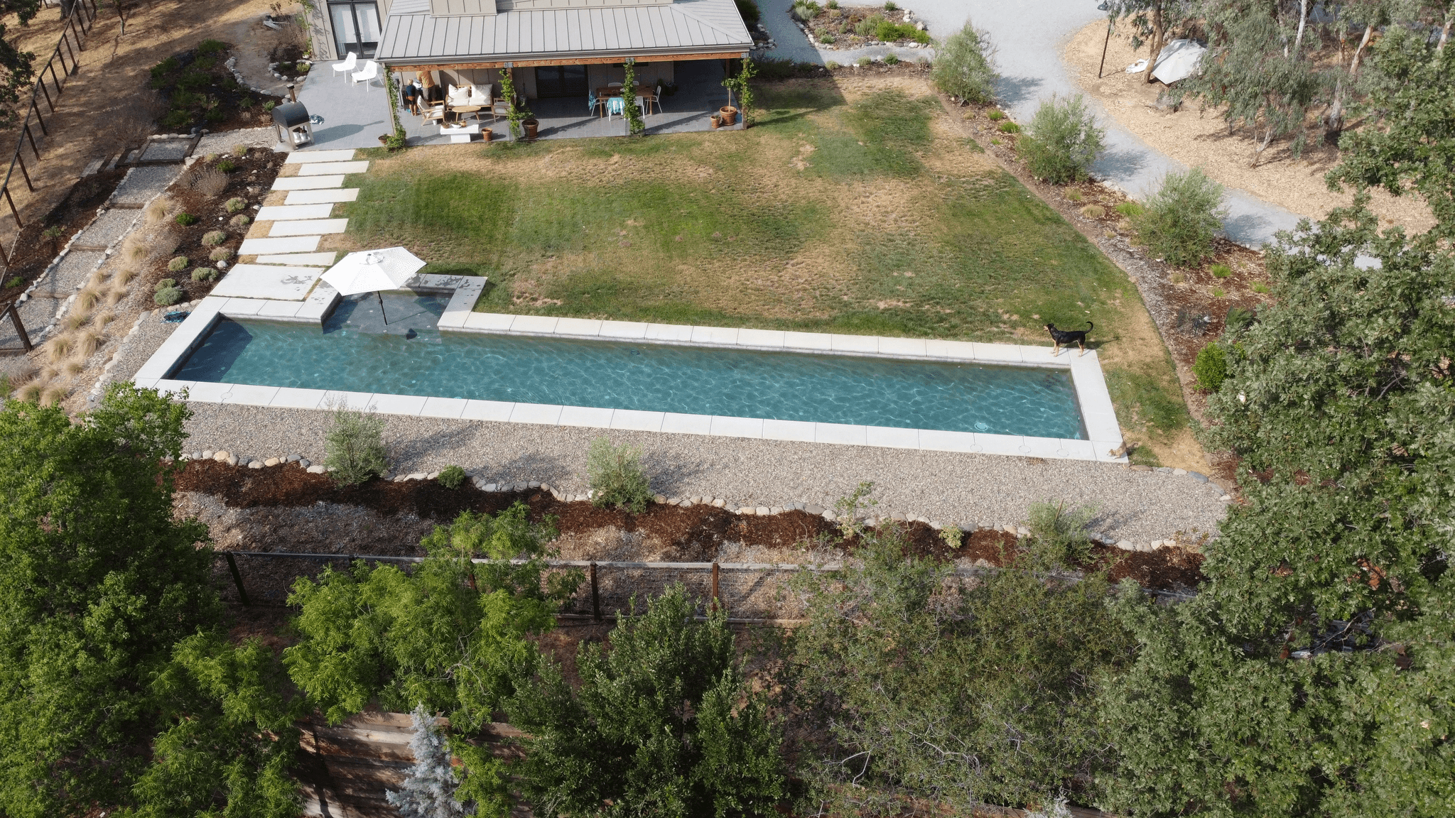 swimming pool decking in a beautifully landscaped corner lot house