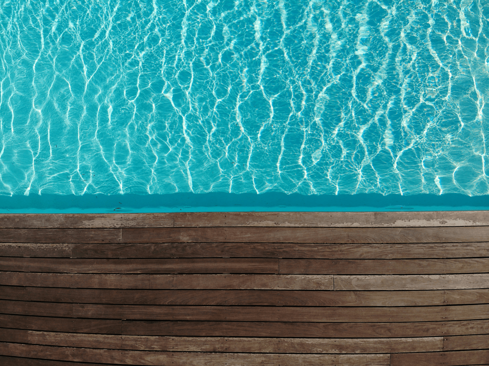 beautiful wood deck around pool enhancing outdoor living space