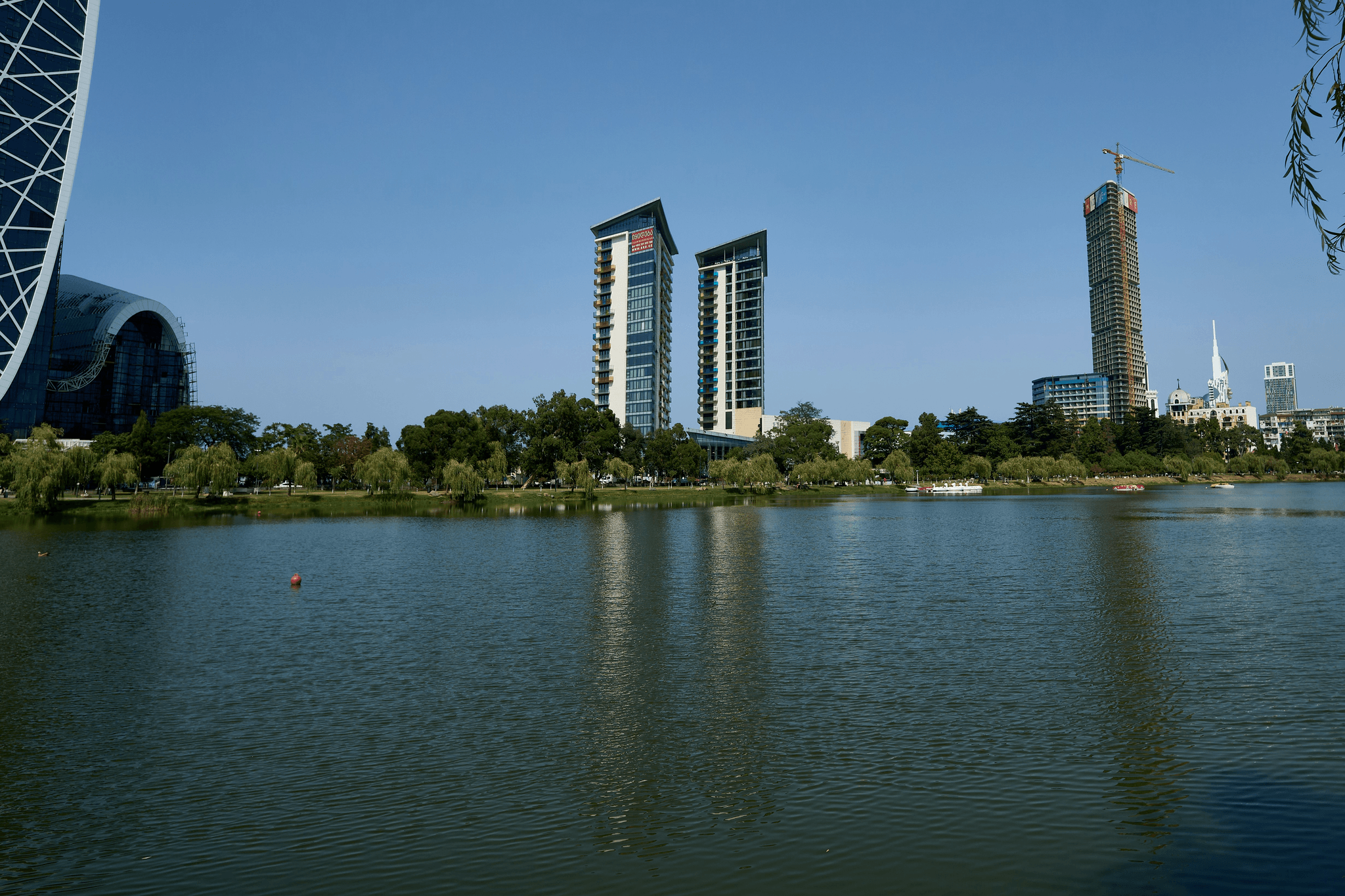 Aerial view of West Lake with modern buildings surrounding it qflp