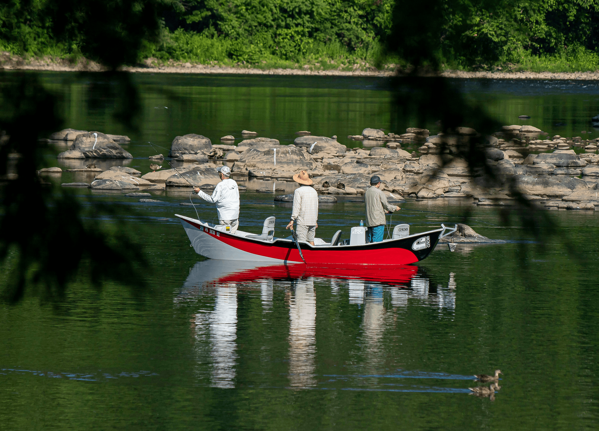 Different types of freshwater fishing boats on a serene lake