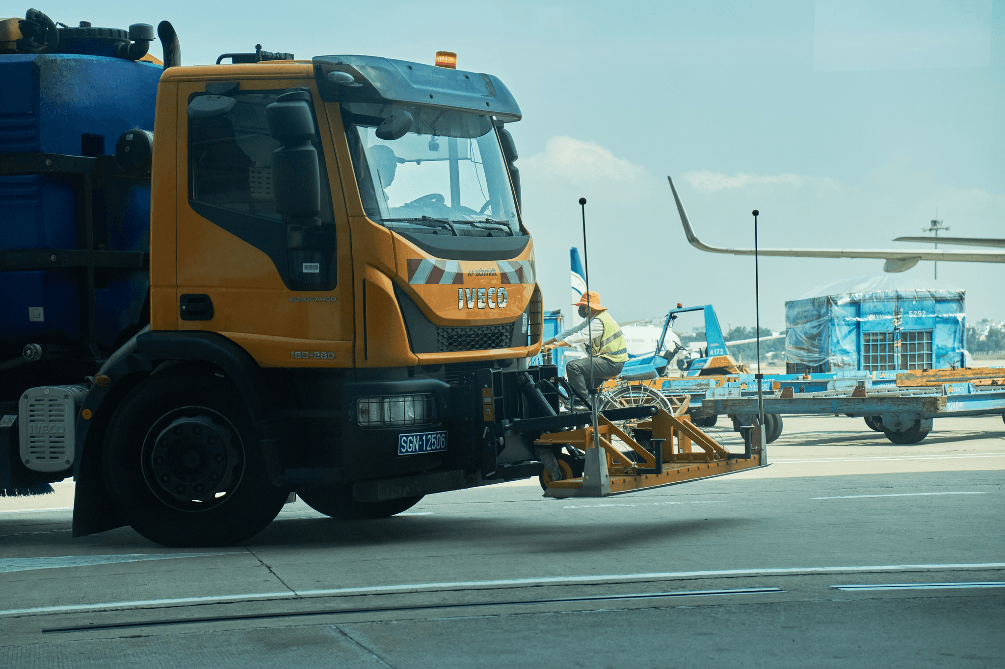 snow blower truck clearing runway at busy airport