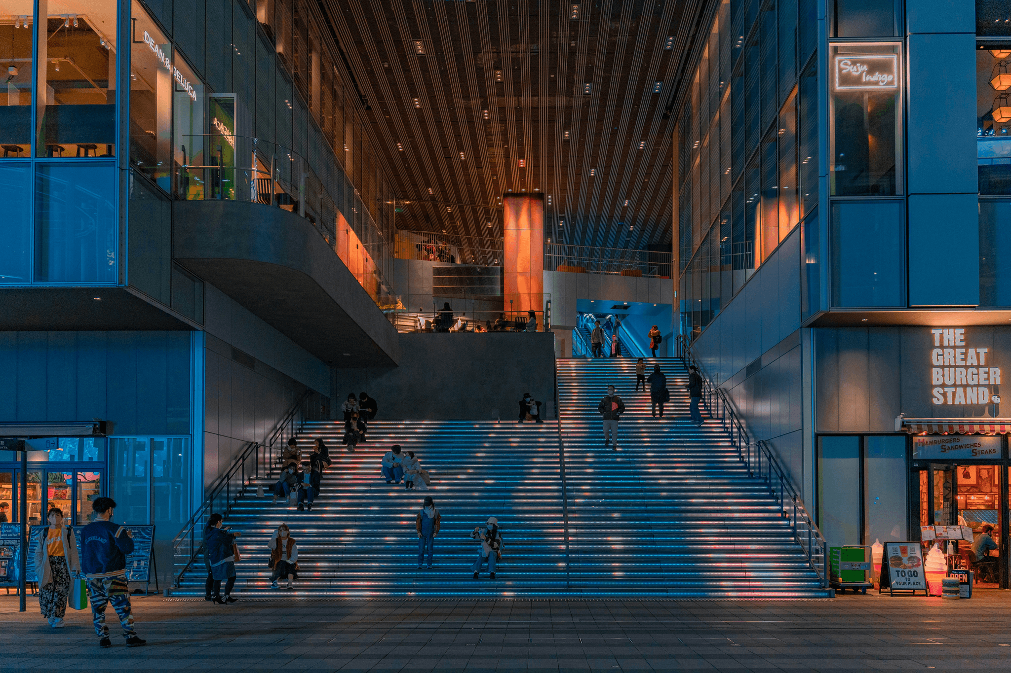 Modern mall elevator design near functional stairways