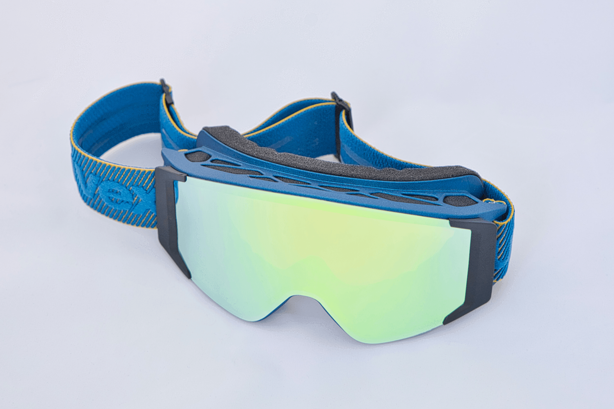 ski googles resting on skis at snowy mountain