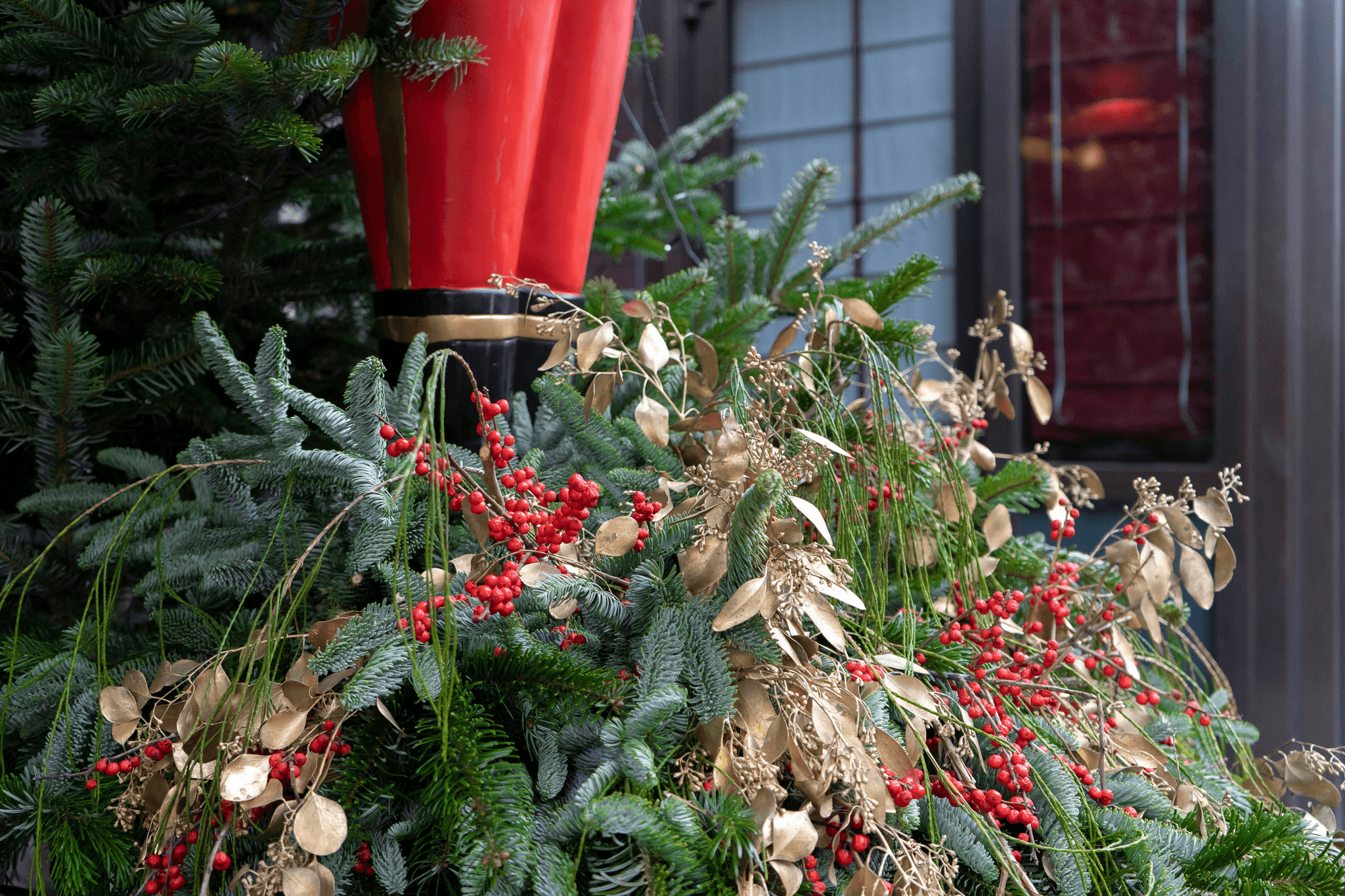 Festive holiday container display on a decorated patio
