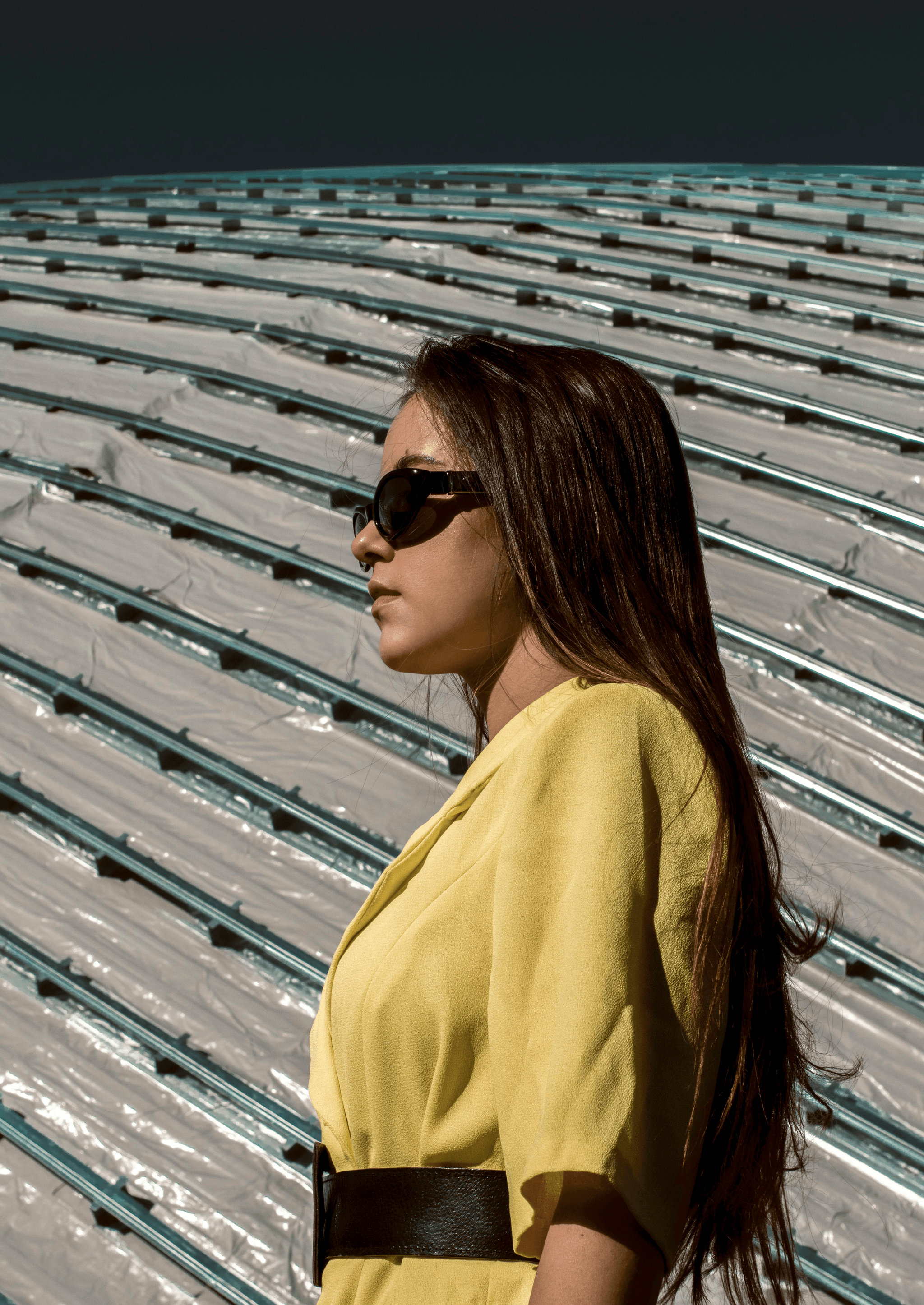 Stylish person wearing yellow tinted prescription glasses outdoors.