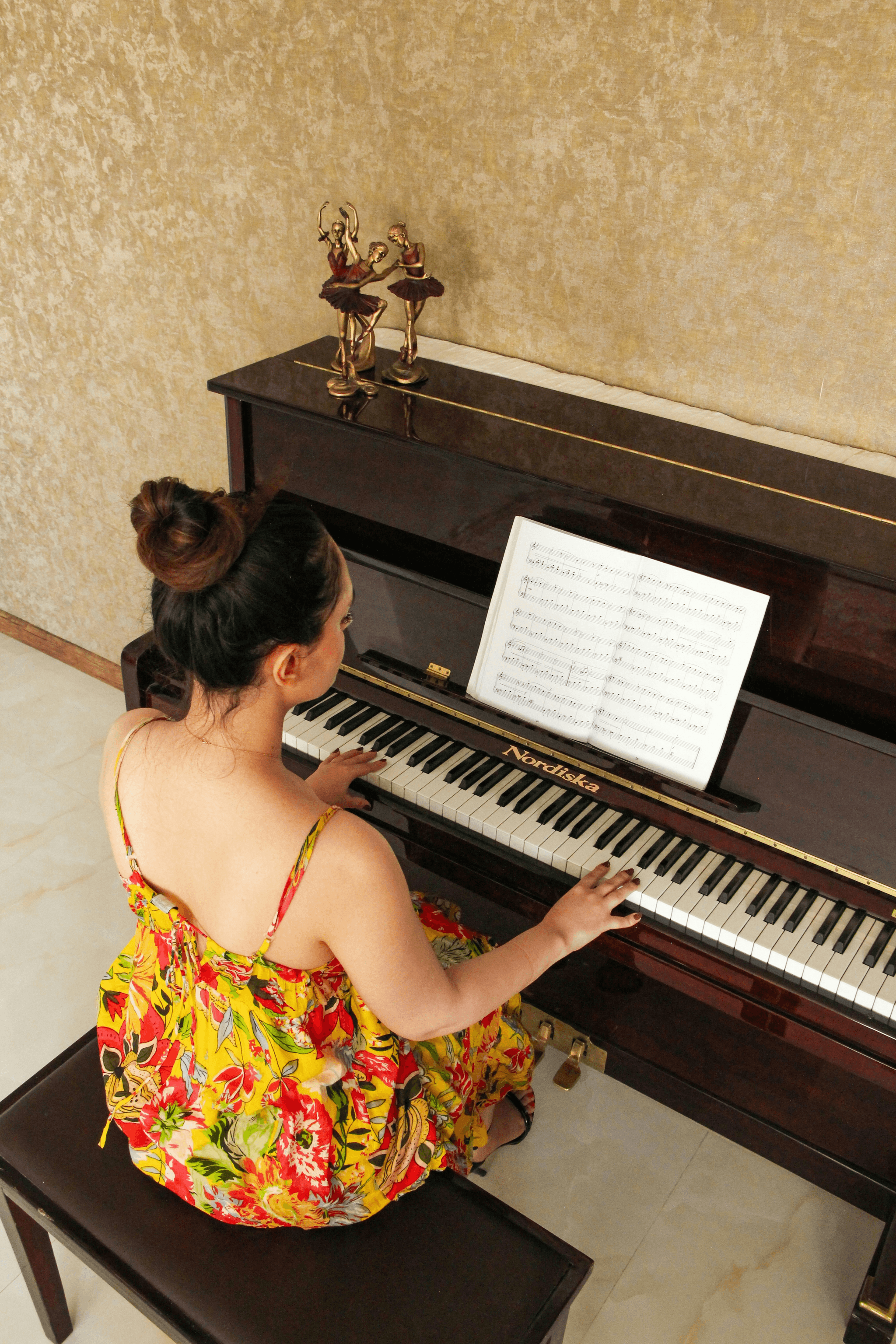 piano student playing on piano keys 