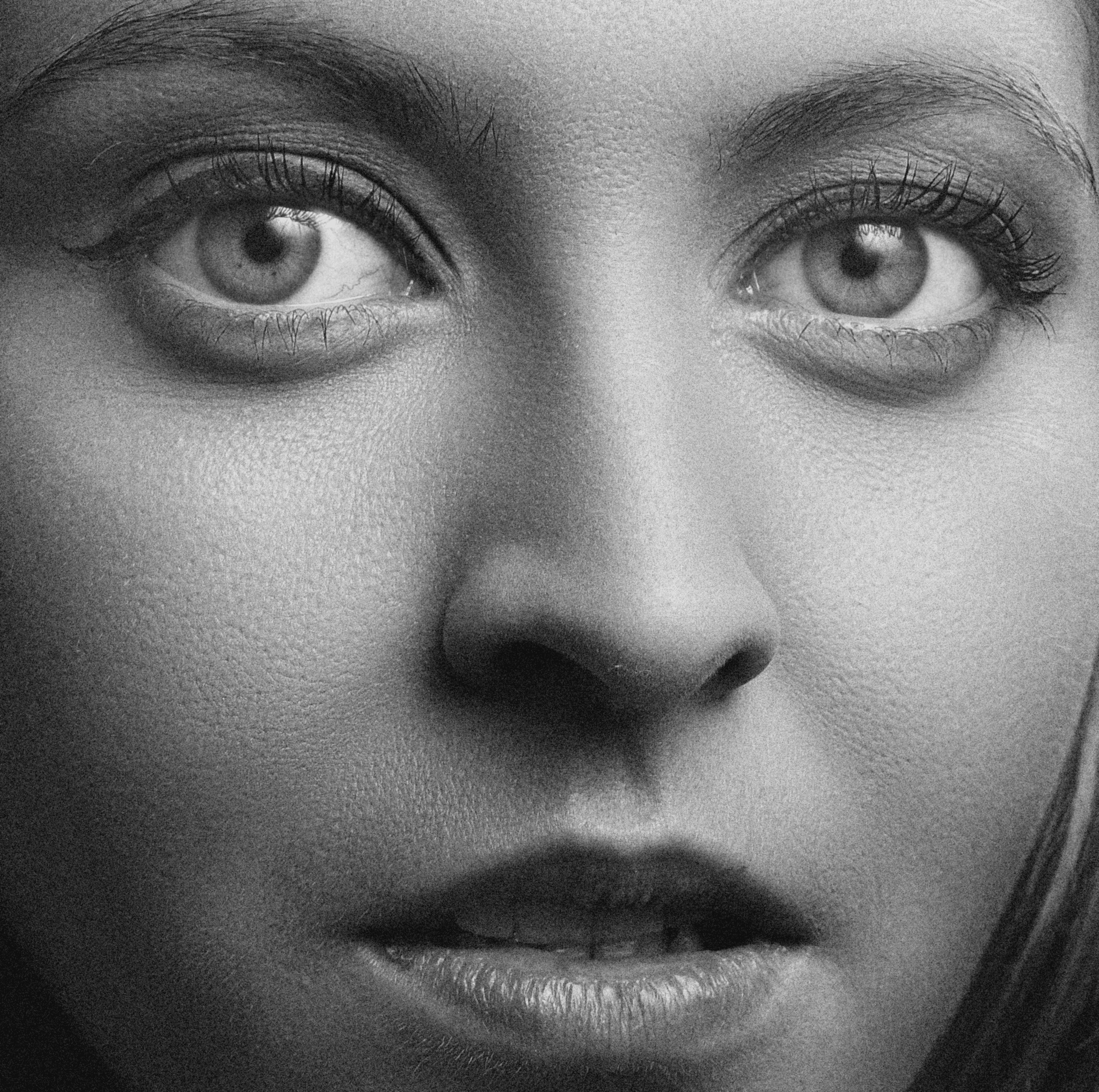 Intense black and white close-up portrait of a woman's face representing targeted hormone harmony and metabolism support by Lady Reset